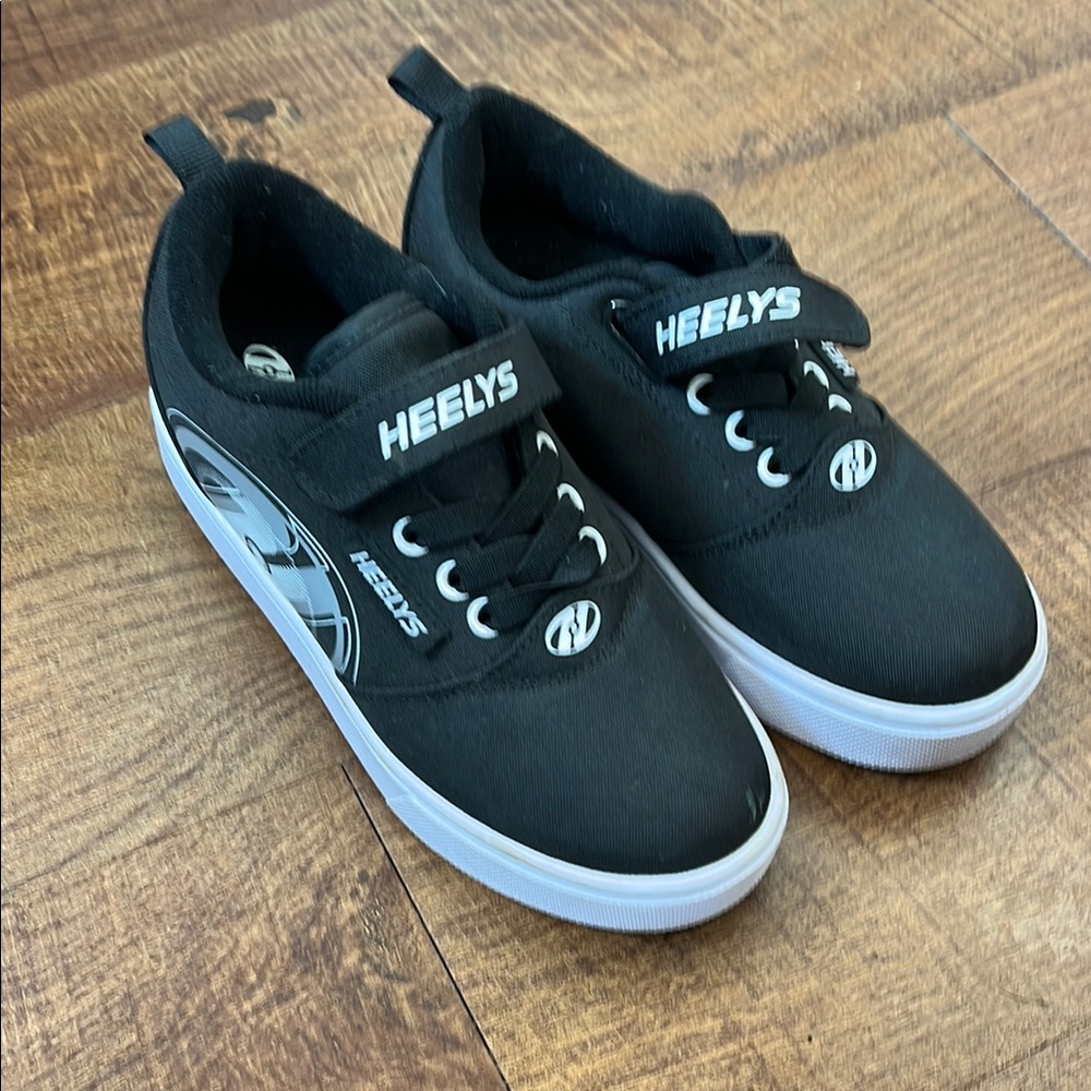 One pair barely used black and white Heelys, Pro 20 X2. Comes with all 4 wheels
